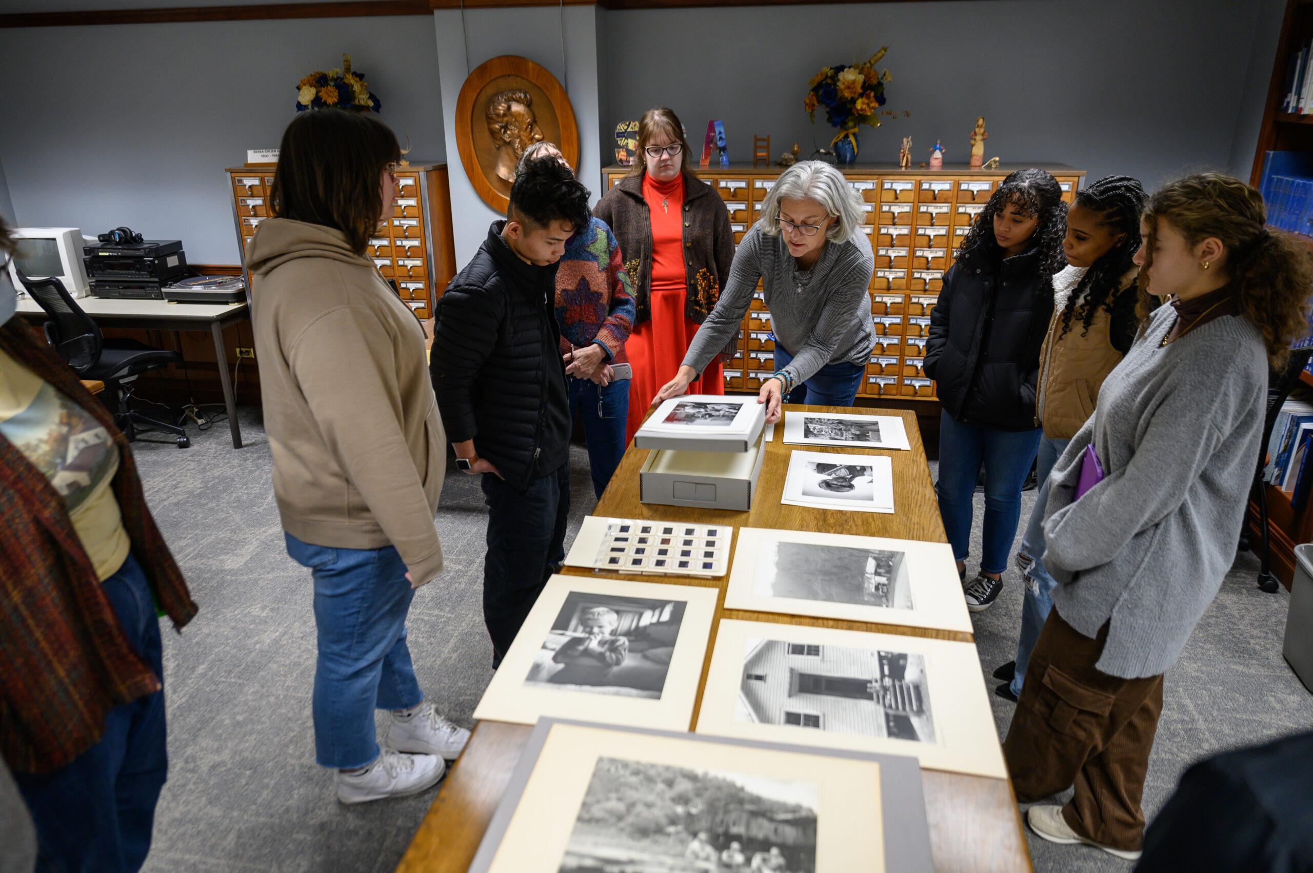Students and the professor looking at art in an exhibit